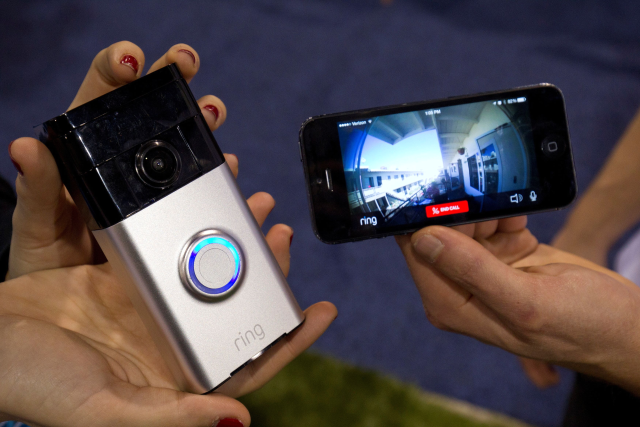A Ring video doorbell (L) is displayed during the 2015 International Consumer Electronics Show (CES) in Las Vegas, Nevada January 7, 2015. The doorbell connects with home Wi-Fi to send a video call to the homeowner's smartphone. REUTERS/Steve Marcus