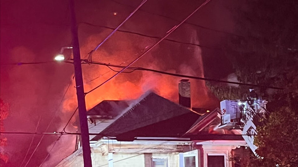  Heavy flames shoot through the roof of New Bedford home