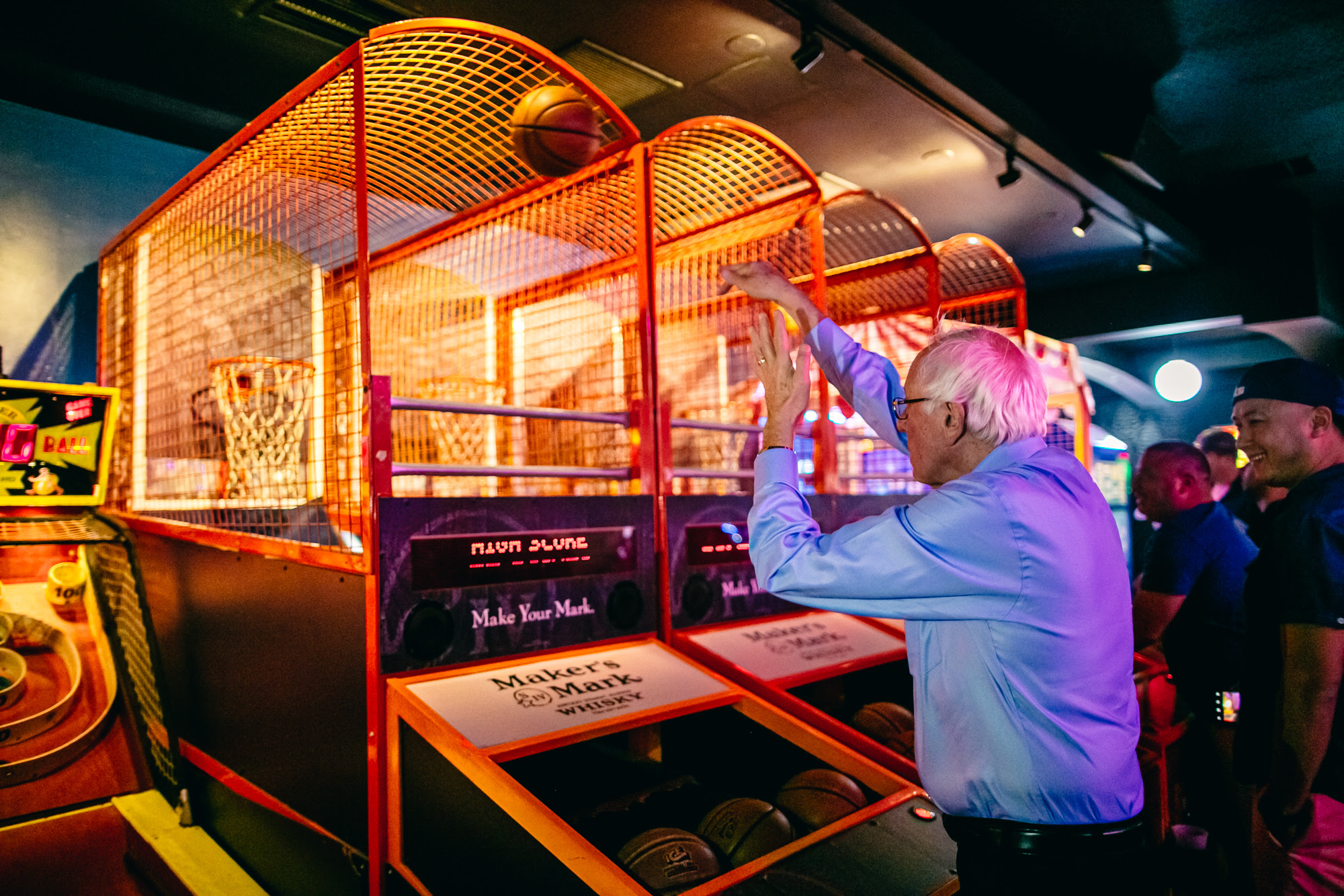 Bernie at an arcade shooting a basketball