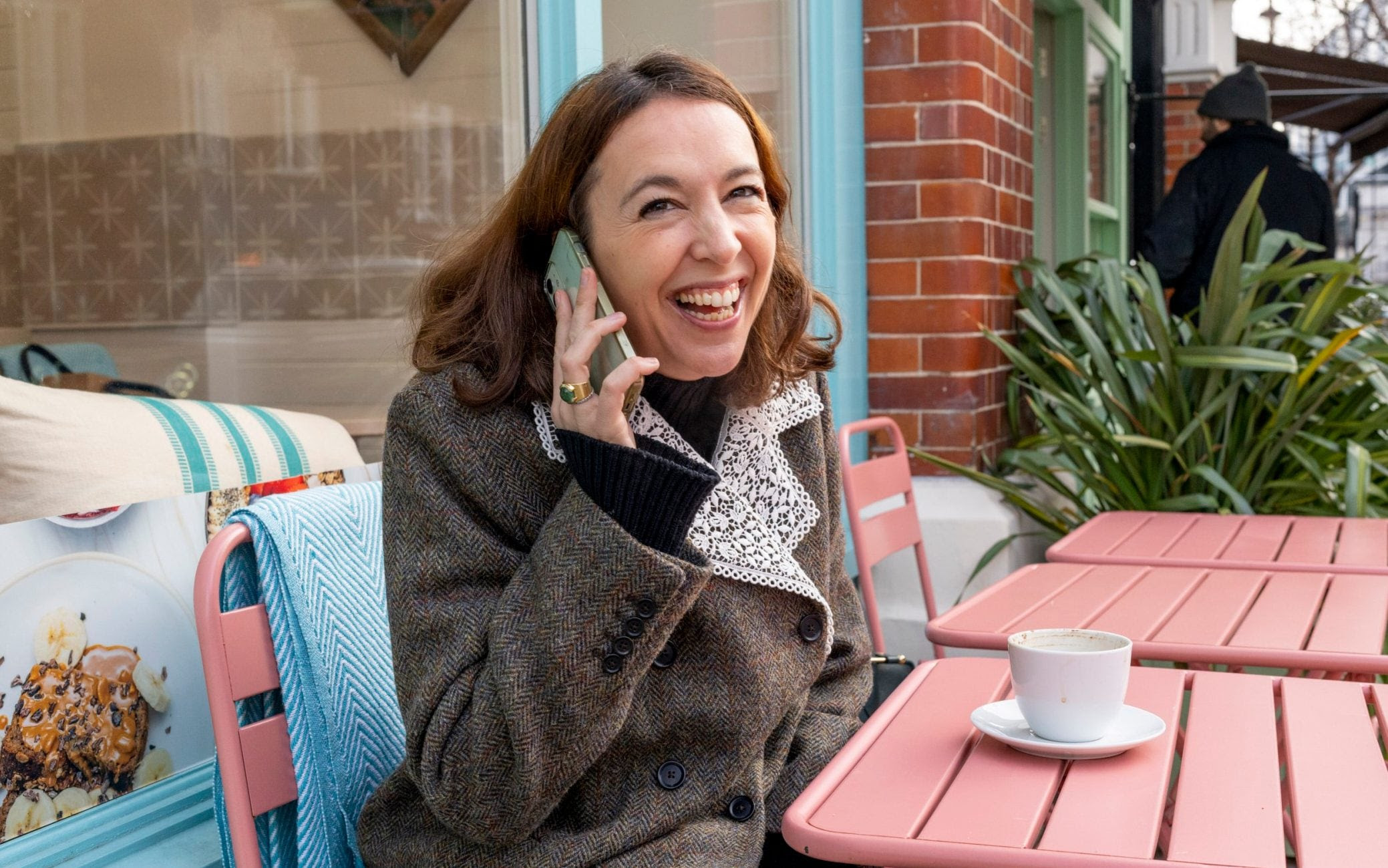 A woman on the phone, smiling