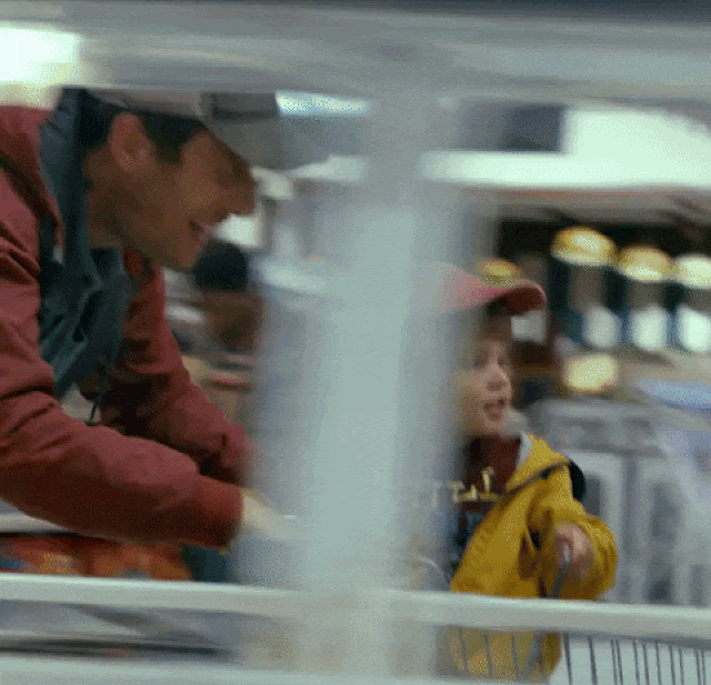 Gif of a father and son playing in a supermarket