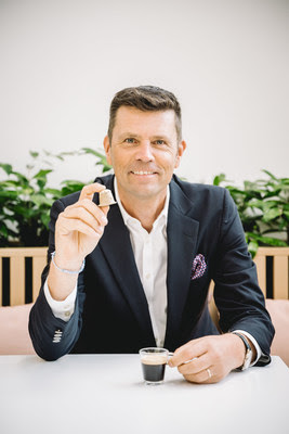 Nespresso CEO Guillaume Le Cunff with Nespresso’s new paper-based home compostable capsule