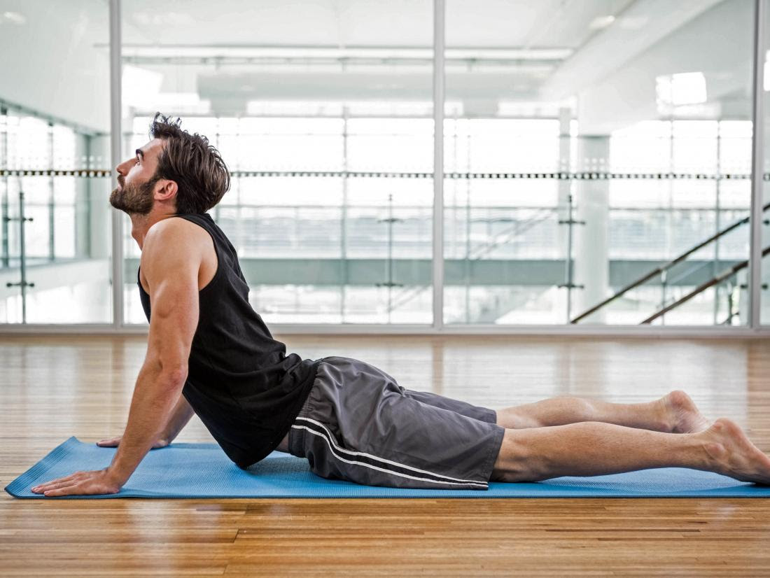 a man doing cobra yoga pose.