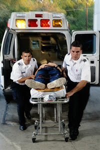Photo: EMS workers moving a patient from an ambulance