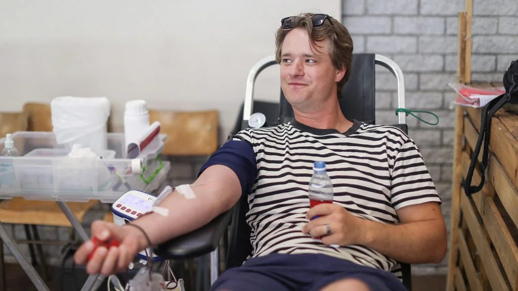 a man sat in a chair donating plasma