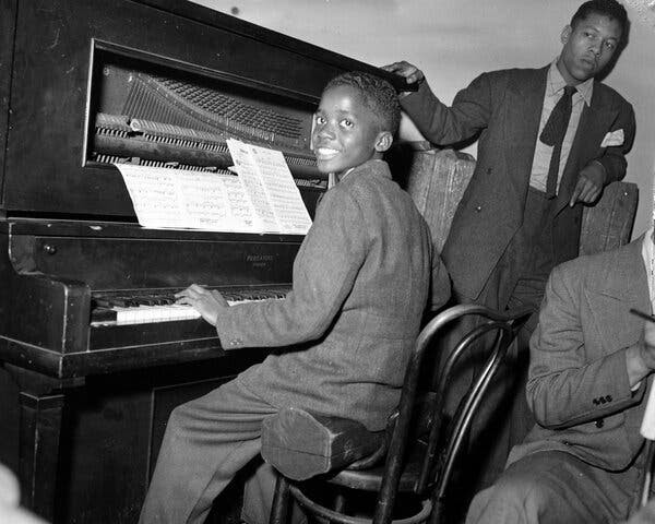 Mr. Jamal, seated at the piano, circa 1942, in his hometown, Pittsburgh.