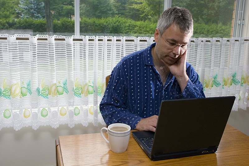 Man at computer attending webinar