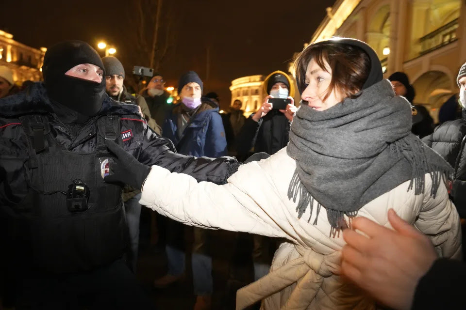 A police officer detains a woman during a gathering in St. Petersburg, Russia, Thursday, Feb. 24, 2022, after Russia's attack on Ukraine. Hundreds of people gathered in the center of Moscow on Thursday, to protest against Russia's attack on Ukraine and many of the demonstrators were detained. Similar protests took place in other Russian cities, where activists were also arrested. (AP Photo/Dmitri Lovetsky)