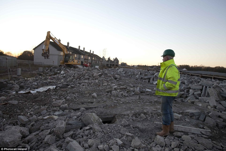 Not economically viable: A contractor stands in the rubble of the Glenatore ghost estate. Thousands of housing estates built during the Celtic Tiger boom years were abandoned following the late 2000s recession