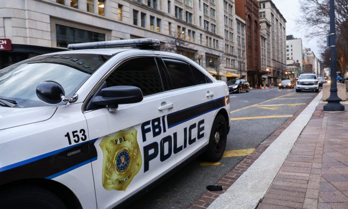 An FBI Police car is parked outside FBI Headquarters in Washing
