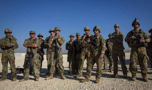 In this Monday, Nov. 11, 2019, file photo, crewmen of Bradley fighting vehicles stand guard at a U.S. military base in Northeastern Syria. Iran has had its fingers in Iraq&#39;s politics for years, but the U.S. killing of an Iranian general and Iraqi militia commander outside Baghdad has added new impetus to the effort, stoking anti-Americanism that Tehran now hopes it can exploit to help realize the goal of getting U.S. troops out of the country. (AP Photo/Darko Bandic, File)