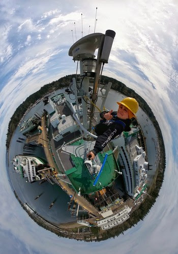 Photo of person at the top of a mast on a ferry