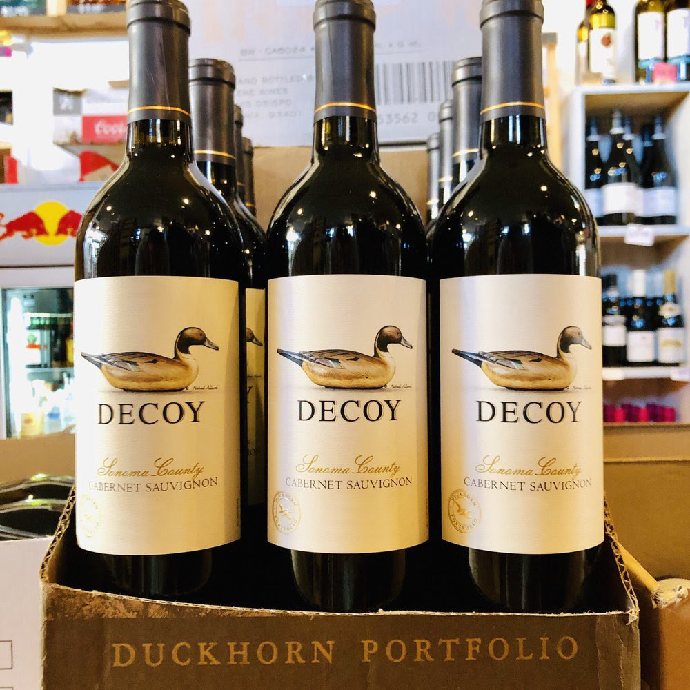 A display case showing 12 bottles of Duckhorn's Decoy Cabernet Sauvignon.