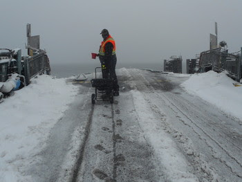 Photo of person salting the vehicle transfer span at Fauntleroy terminal