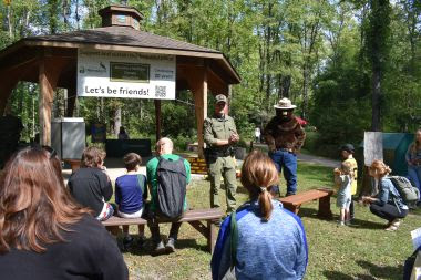 Ranger Thaine and Smokey Bear presenting to a group of people