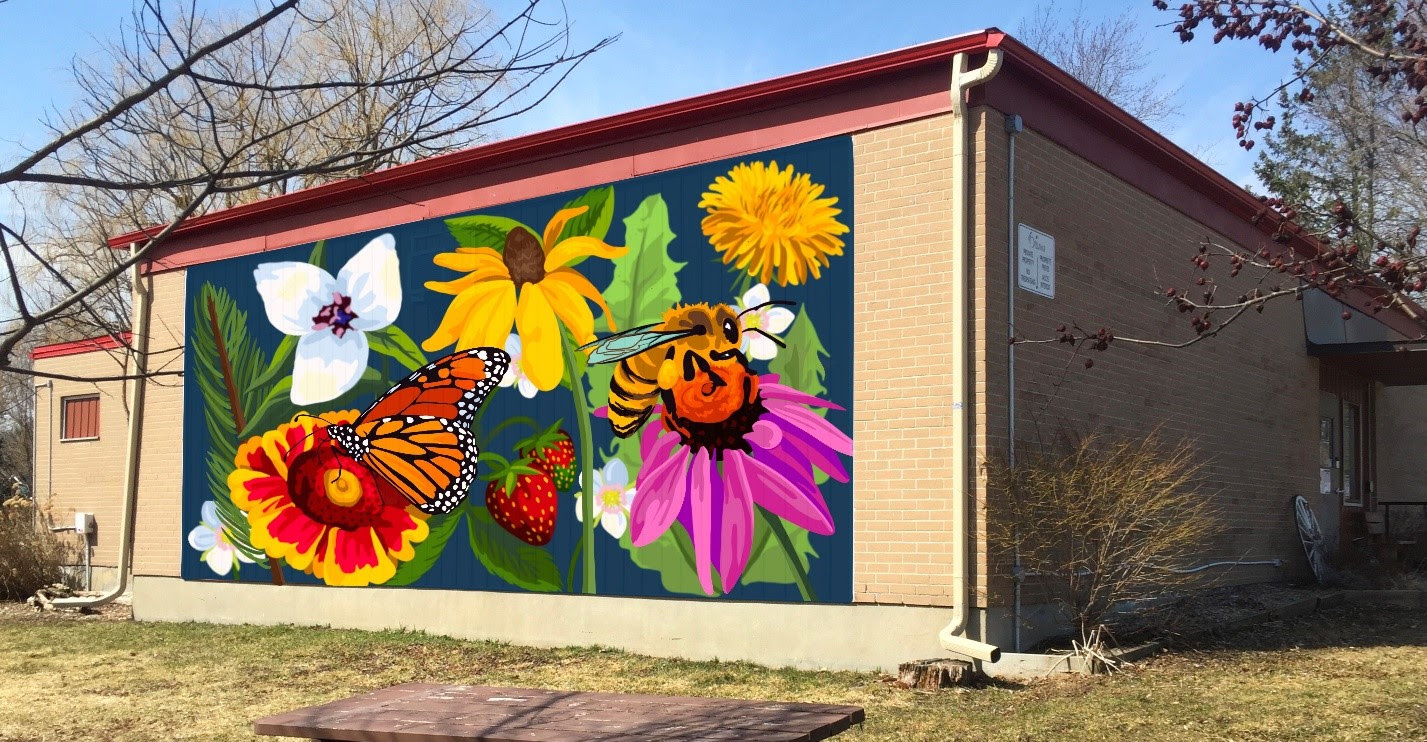 a vibrant painted mural on the wall of a brick building. The mural has flowers, strawberries and a bee.