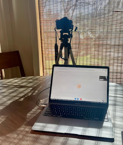 Jeff's POV when doing a television interview. The picture is of a laptop hosting a call and a camera on a tripod behind it.