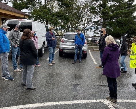 Phot of group of people in circle in a parking lot