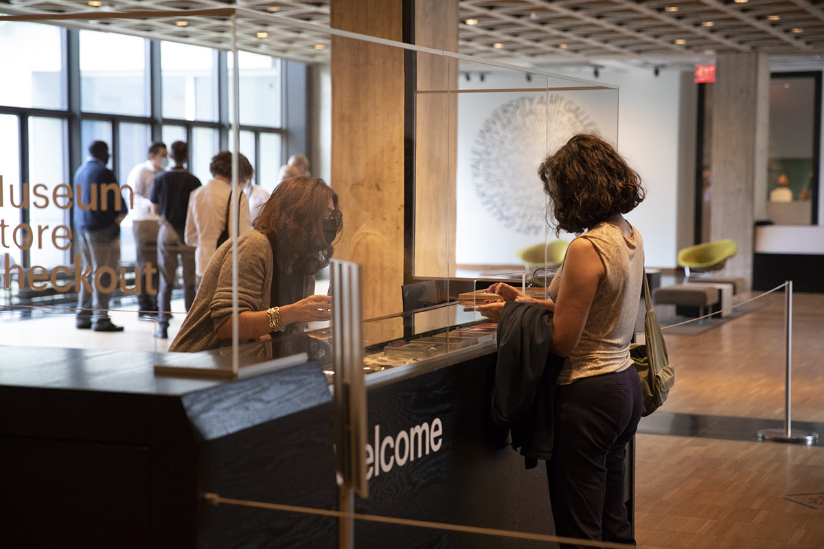  visitor checking in at the Welcome desk in the Gallery's lobby