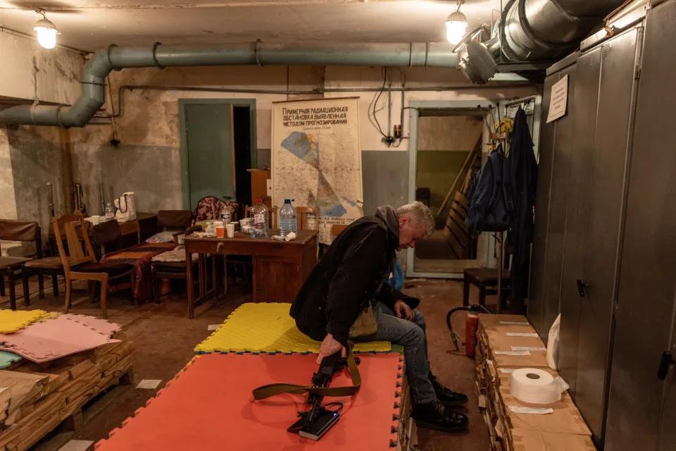 A volunteer rests in a bomb shelter.