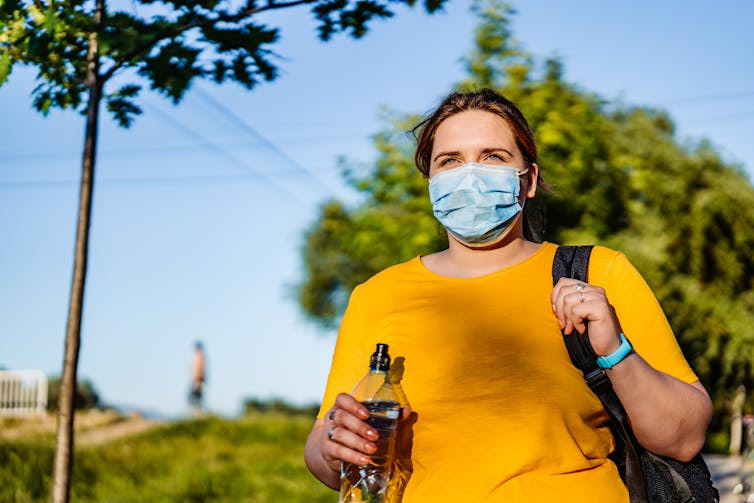 A woman exercising outdoors.