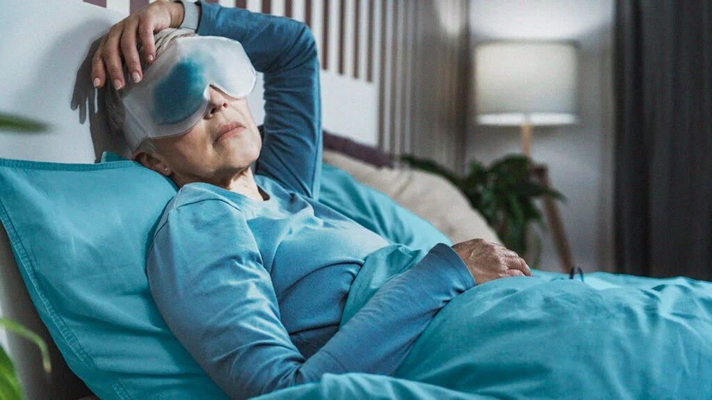 An older person using a cooling mask to try and treat dry eye.