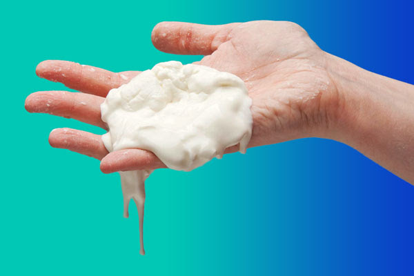 A person's hand holding some cornflour slime