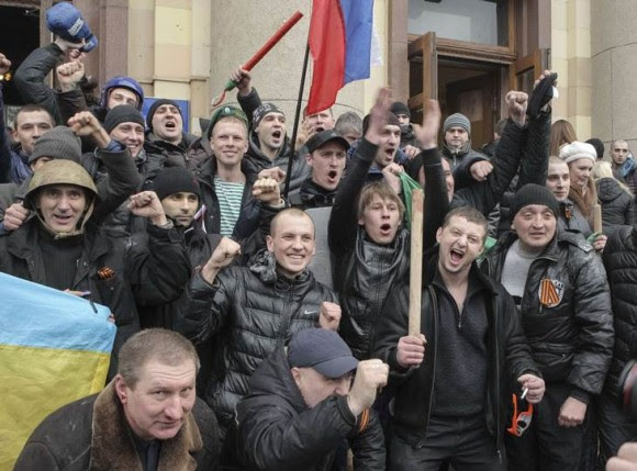 Pro-Russian protesters celebrate after clashes with supporters of Ukraine's new government in central Kharkiv