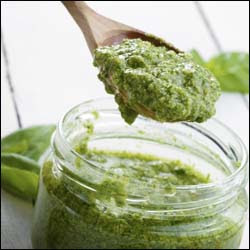 The figure above is a photograph showing a jar of pesto.