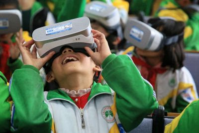 Primary school students wear virtual reality (VR) headsets inside a
classroom in Xiangxi Tujia and Miao Autonomous Prefecture, Hunan province,
China, 14 March 2018 (Photo: Reuters/Stringer).