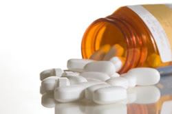 photo: prescription pills spilling out of a bottle