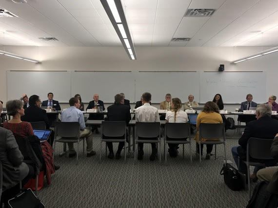 Five students and a teacher sit at a table facing members of the Joint Education Interim Committee to testify about computer science.