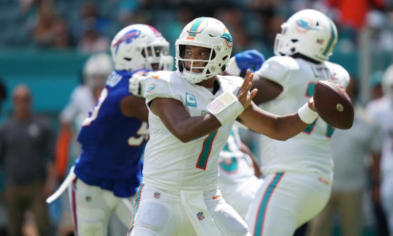 Tua Tagovailoa (#1) drops back to pass for Dolphins versus Bills