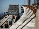 In this July 2, 2018, file photo, traffic moves on the old Gerald Desmond Bridge next to its replacement bridge under construction in Long Beach, Calif. President Donald Trump pronounced himself eager to work with Congress on a plan to rebuild America&#39;s crumbling roads and bridges, but offered no specifics during his State of the Union speech on what kind of deal he would back. (AP Photo/Jae C. Hong, File)