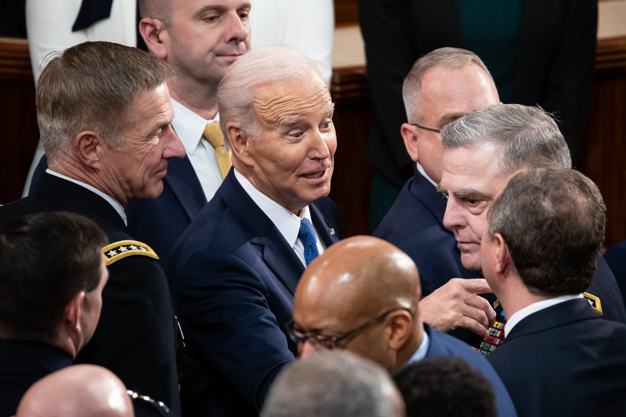 President Joe Biden speaks with Chairman of the Joint Chiefs of Staff Mark Milley after Biden delivered his State of the Union address.