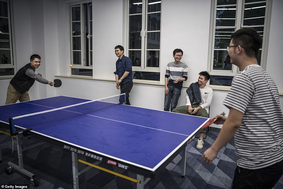 Huawei workers play ping pong in an employee leisure area at the sprawling 'Ox Horn' Research and Development campus