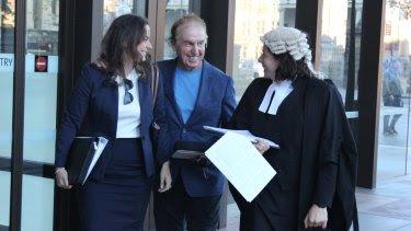 Dr John O'Neill (centre) leaves the NSW Supreme Court on Thursday.
