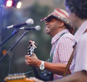 Musician in patriotic hat singing and playing guitar at Red, White and Boom on July 4