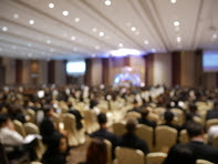 Blurry image of people at a meeting
