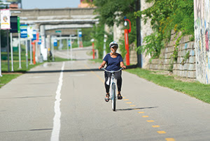 woman riding bike on Dequindre Trail 