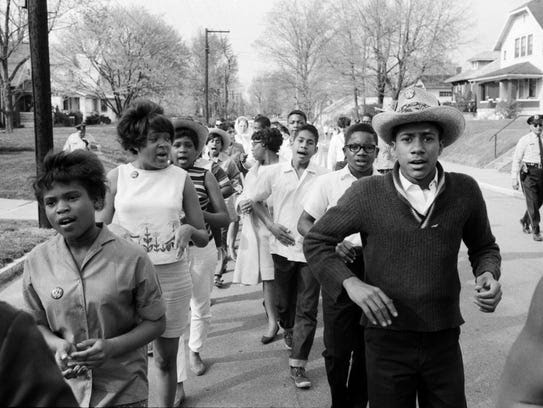 Participants held hands during an open housing march