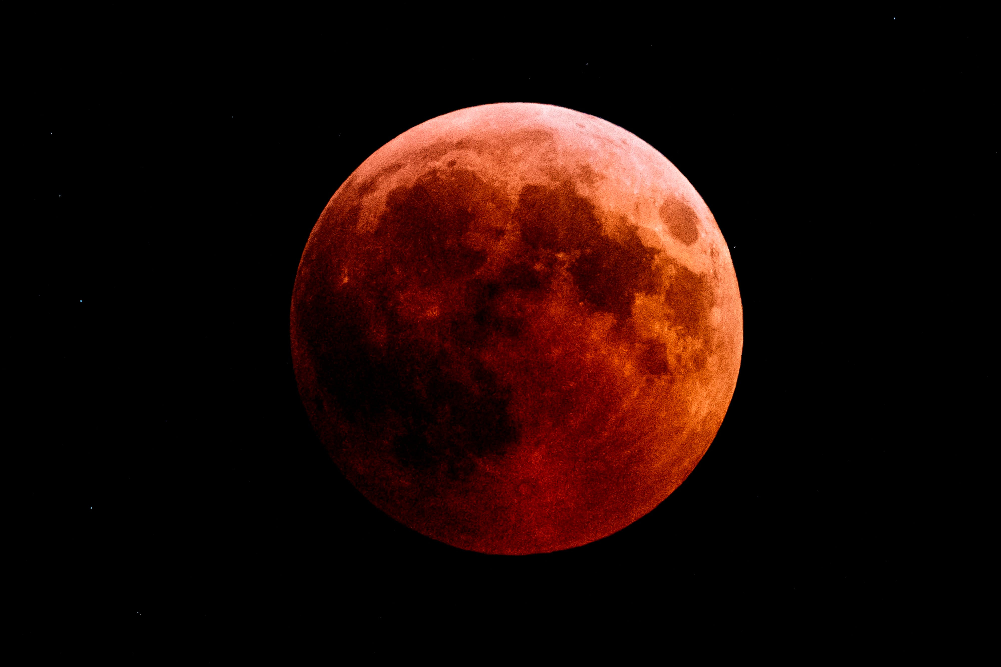A photo of a red colored moon during an eclipse 