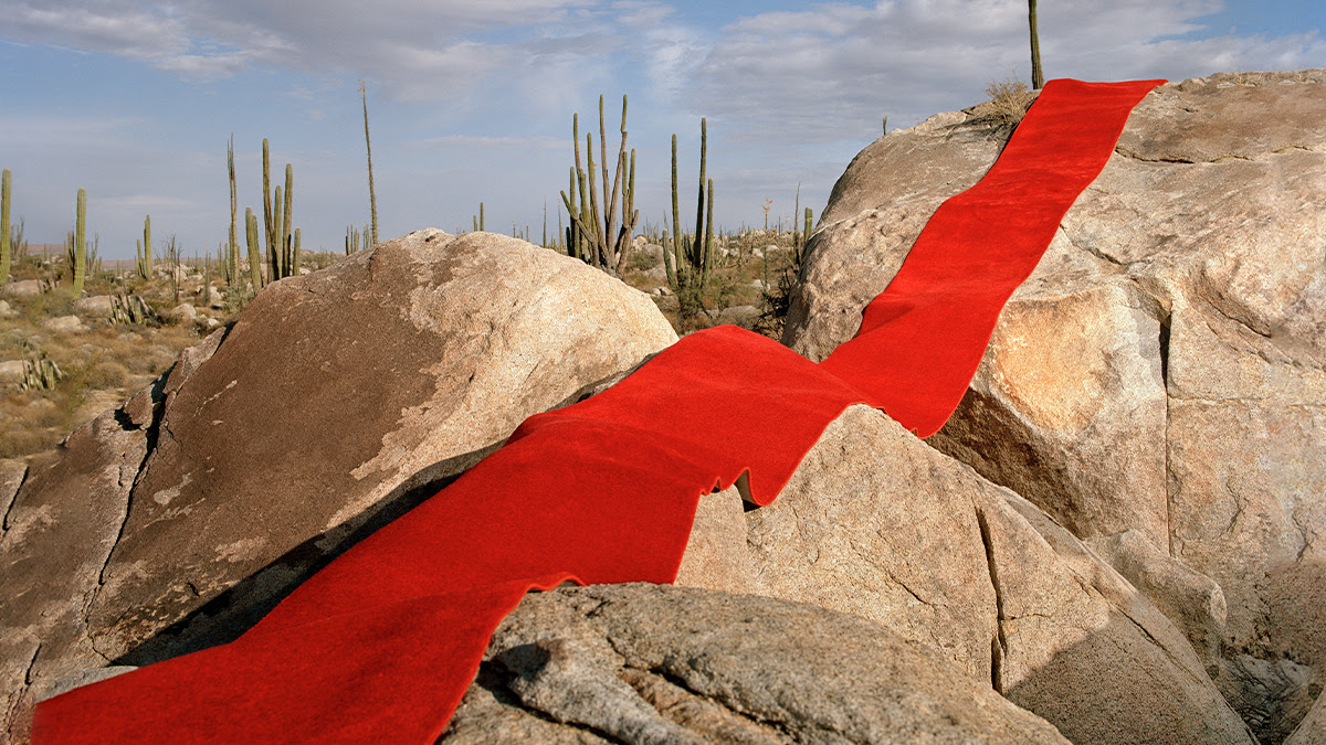 Rocks with red carpet laid out on top 