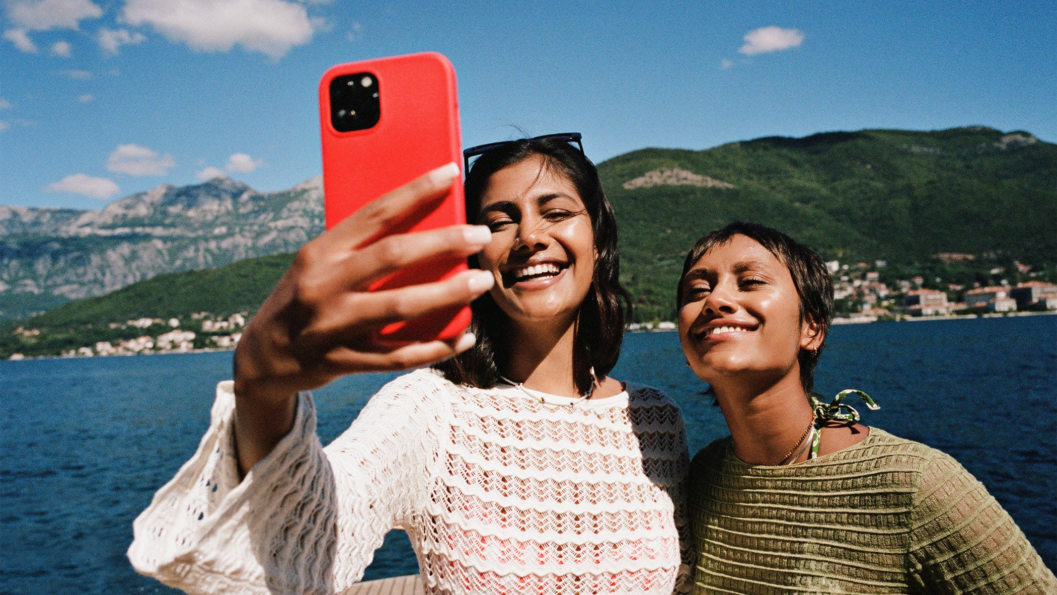 two women smiling and taking a selfie on vacation.