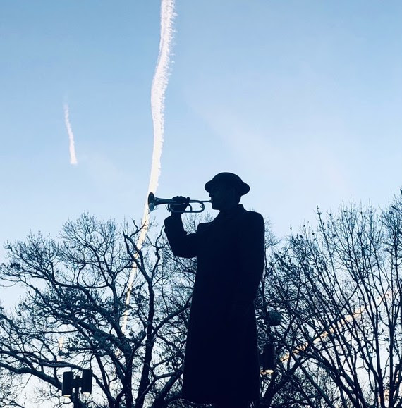 Taps Bugler with sky