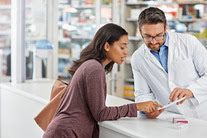 Woman looking at prescription at pharmacy