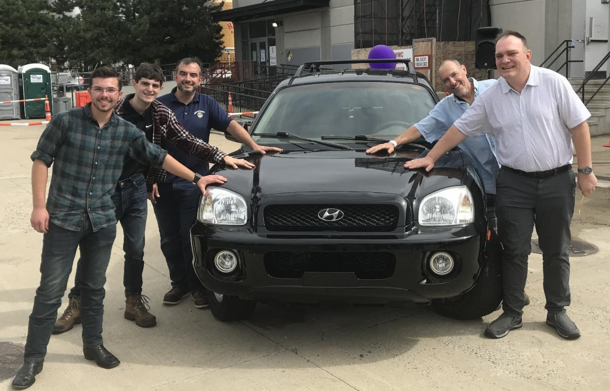 From left: Minuteman High School Automotive Technology students Cole Traywick of Acton and Samuel Staiti of Arlington, both juniors, with teacher John Primpas; Dan Holin, executive director of Second Chance Cars; and John Harrold, a recently homeless U.S. Army and Navy veteran who received the car through a low-cost, no-interest loan.