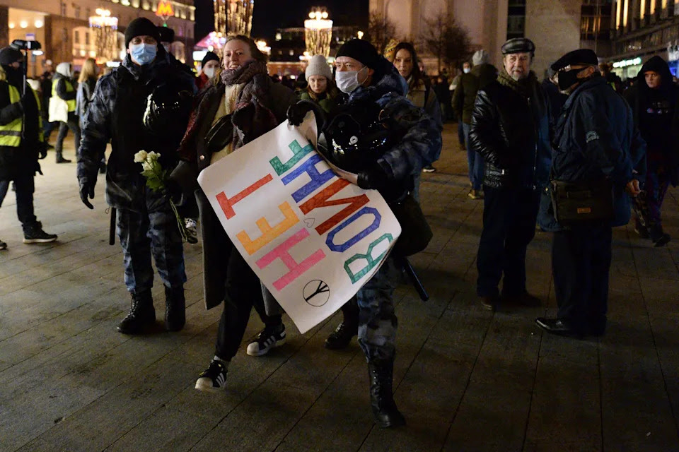 Police officer detain a demonstrator with the poster reading No war during an action against Russia's attack on Ukraine in Moscow, Russia, Thursday, Feb. 24, 2022. Hundreds of people gathered in the center of Moscow and St. Petersburg on Thursday, protesting against Russia's attack on Ukraine. Many of the demonstrators were detained. Similar protests took place in other Russian cities, and activists were also arrested. (AP Photo/Denis Kaminev)