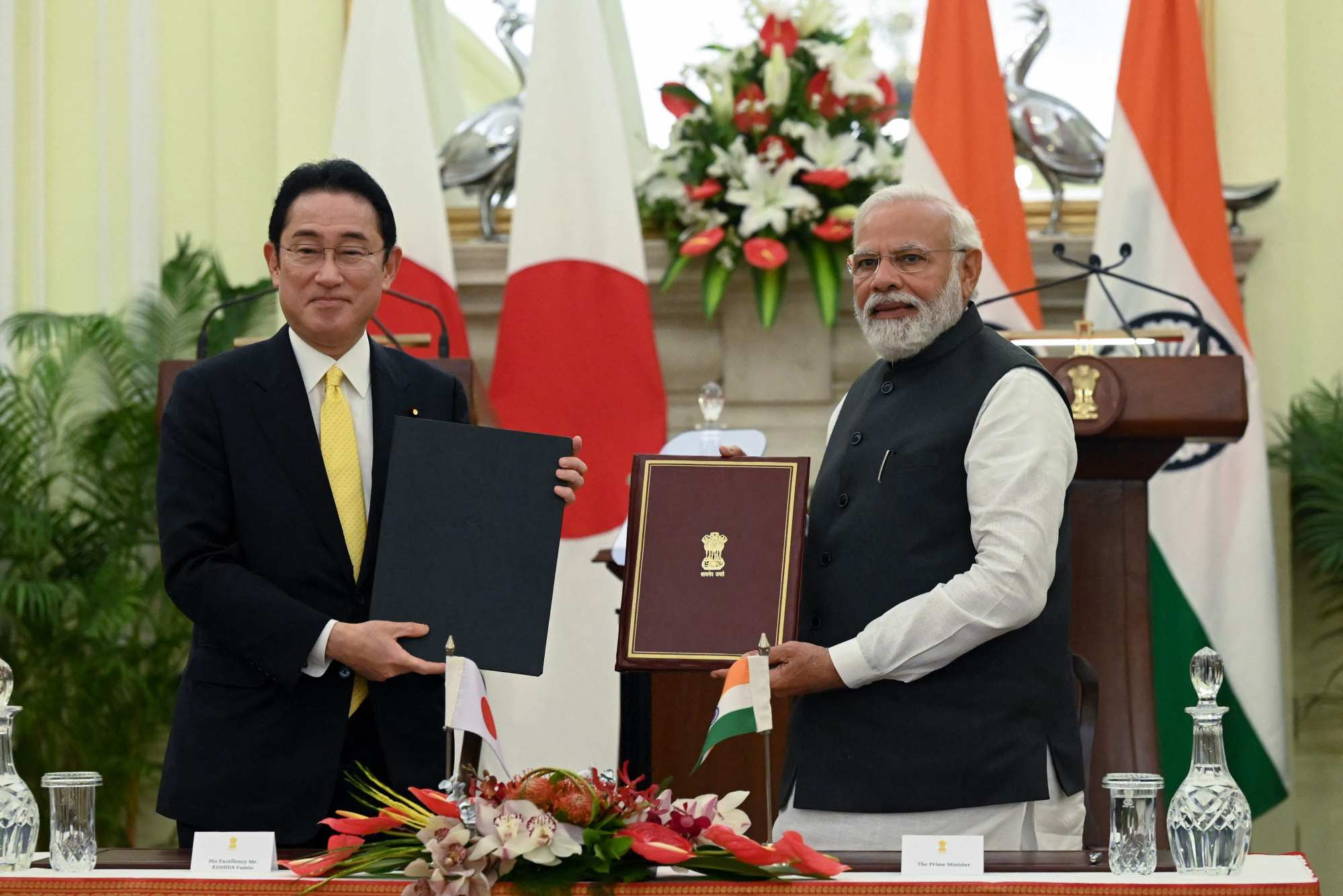 India’s Prime Minister Narendra Modi and Japan’s Prime Minister Fumio Kishida sign an agreement in New Delhi. Photo: AFP