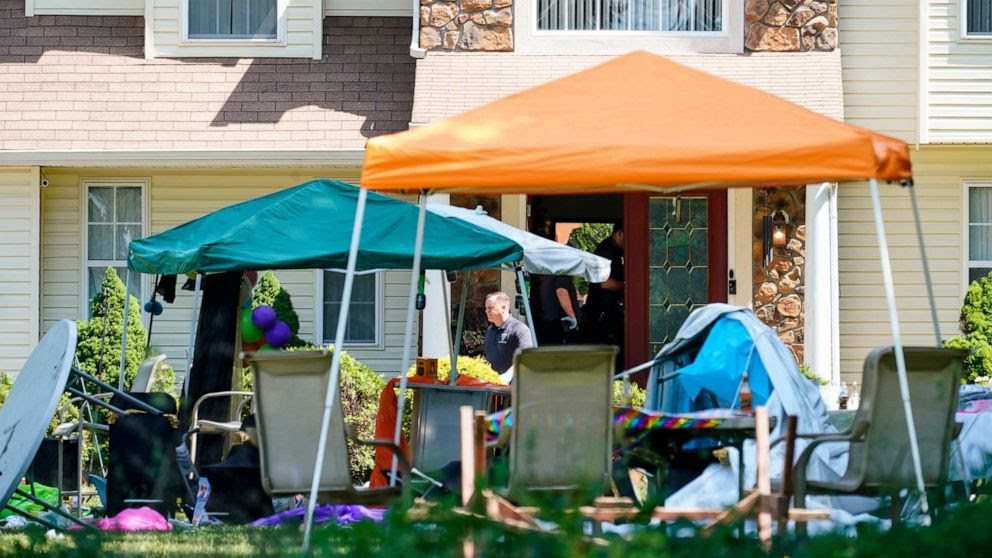 Officials investigate the abandoned birthday-party scene after a shooting